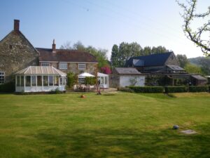 Listed barn - view from garden with solar panels fitted