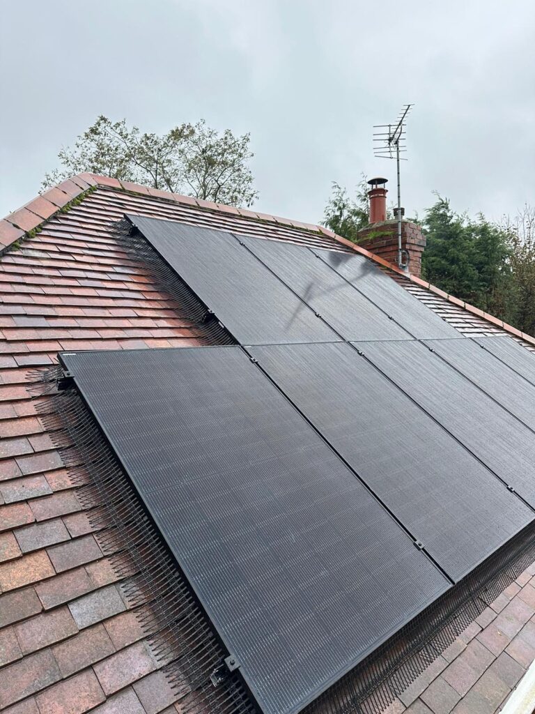 Black solar panels on a house roof.