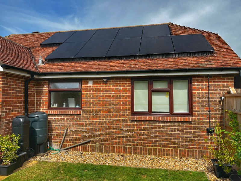 A finished installation with Jinko solar panels on a bungalow.