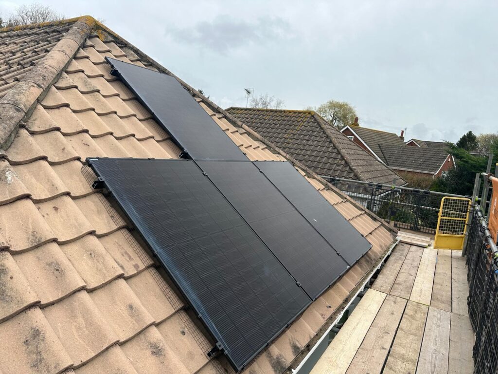 A completed installation with Jinko 435w solar panels on a concrete roof.