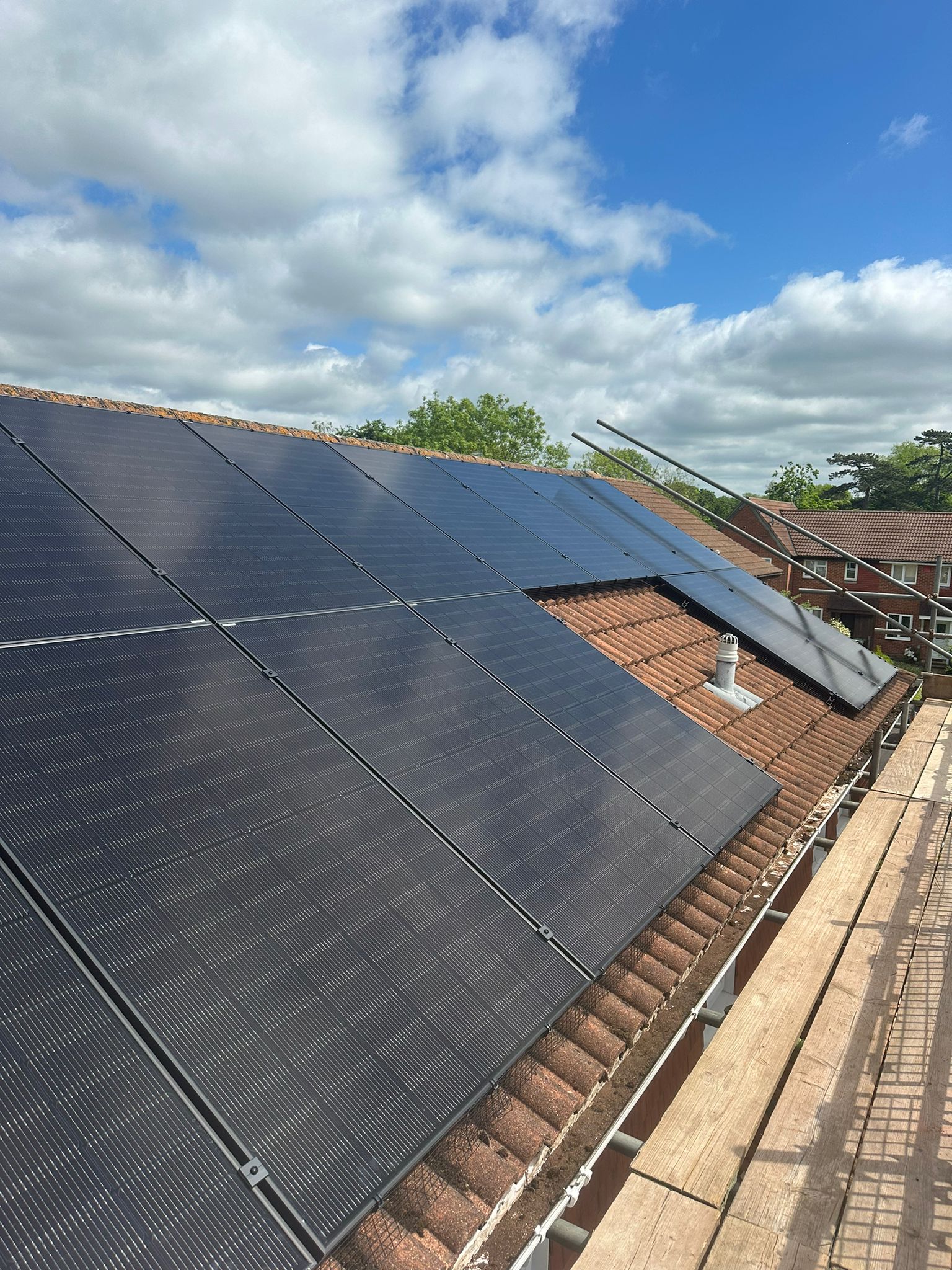 All black Jinko solar panels installed on a concrete tile roof.