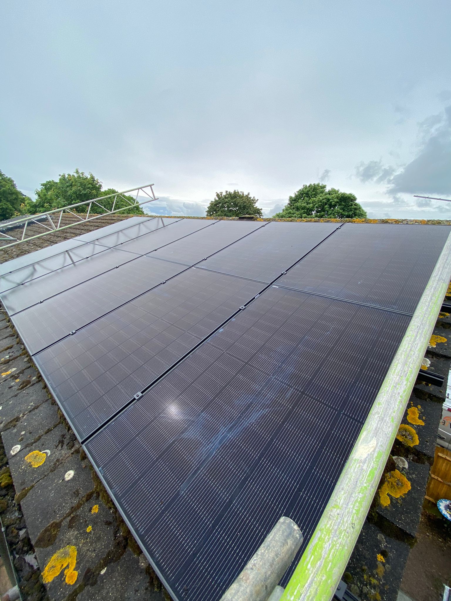 All black Jinko solar panels installed on a concrete tile roof.