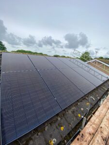 All black Jinko solar panels installed on a concrete tile roof.