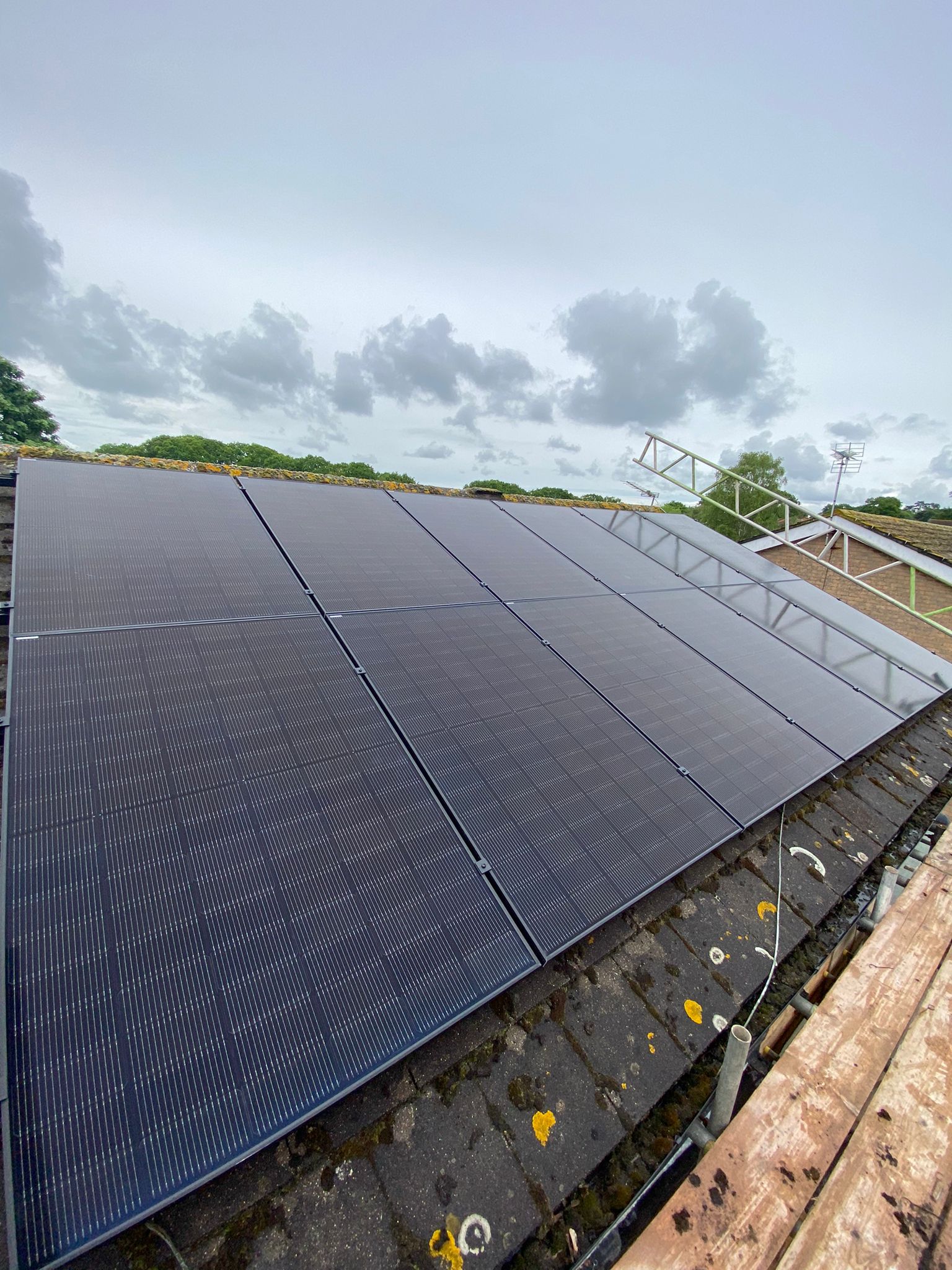All black Jinko solar panels installed on a concrete tile roof.